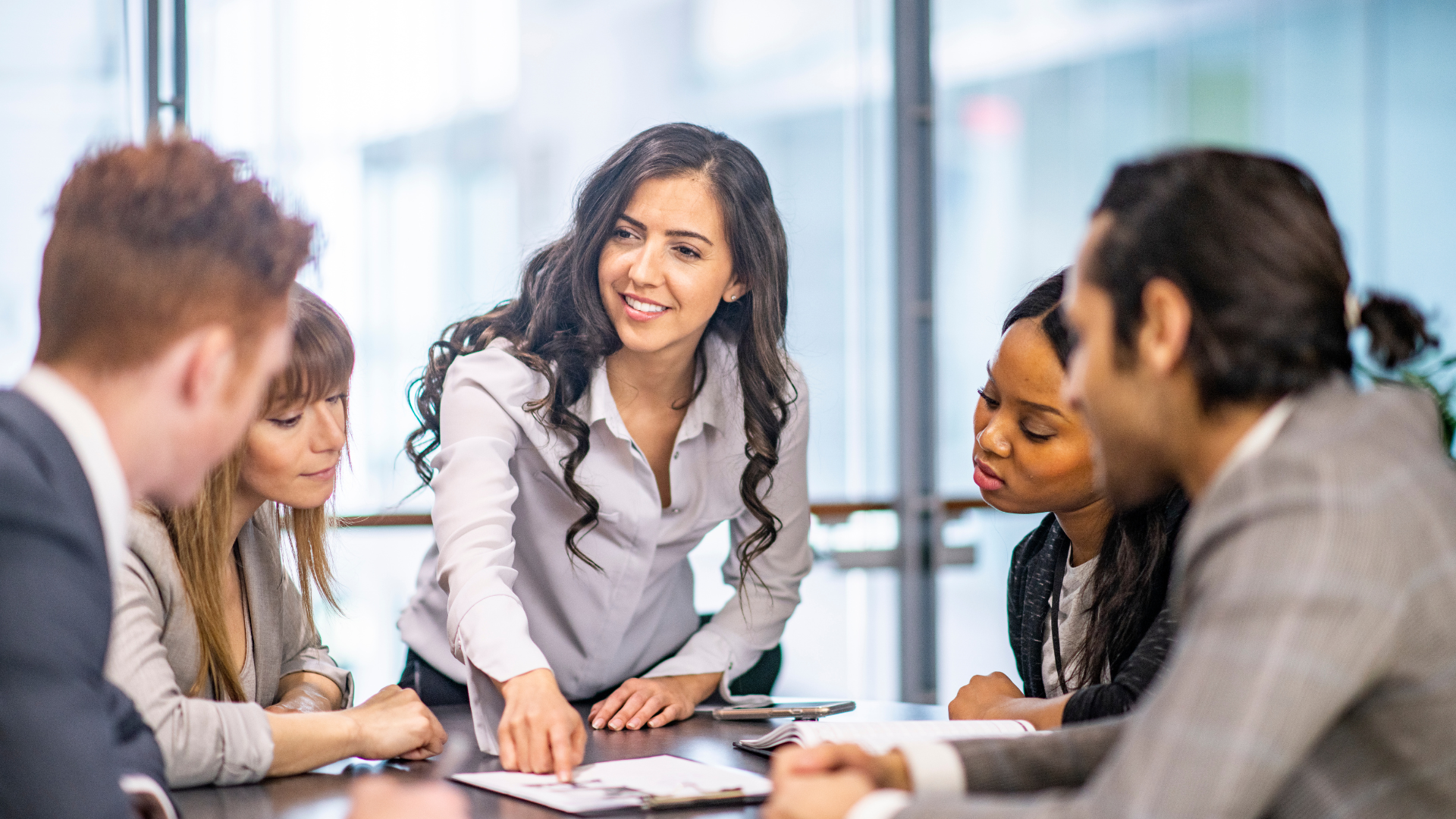 A legal team collaborating in a modern office, discussing how customer feedback and complaints can drive product improvements and business innovation.