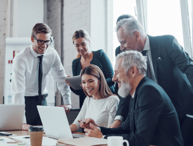 Product team and in-house counsel collaborating in front of a computer on AI product compliance and innovation.