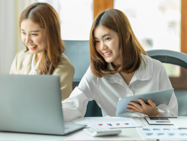 A modern corporate lawyer in a bright office, reviewing documents with colleagues, professional and focused atmosphere.
